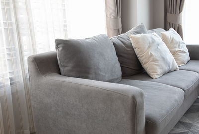 Close-up of white sofa on bed at home