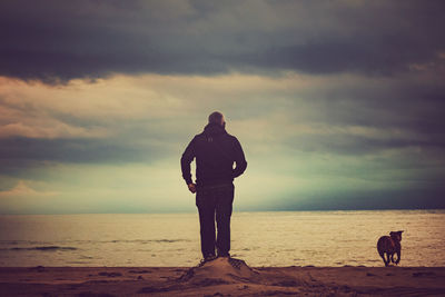 Man standing on beach against sky