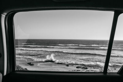 Scenic view of sea seen through glass window