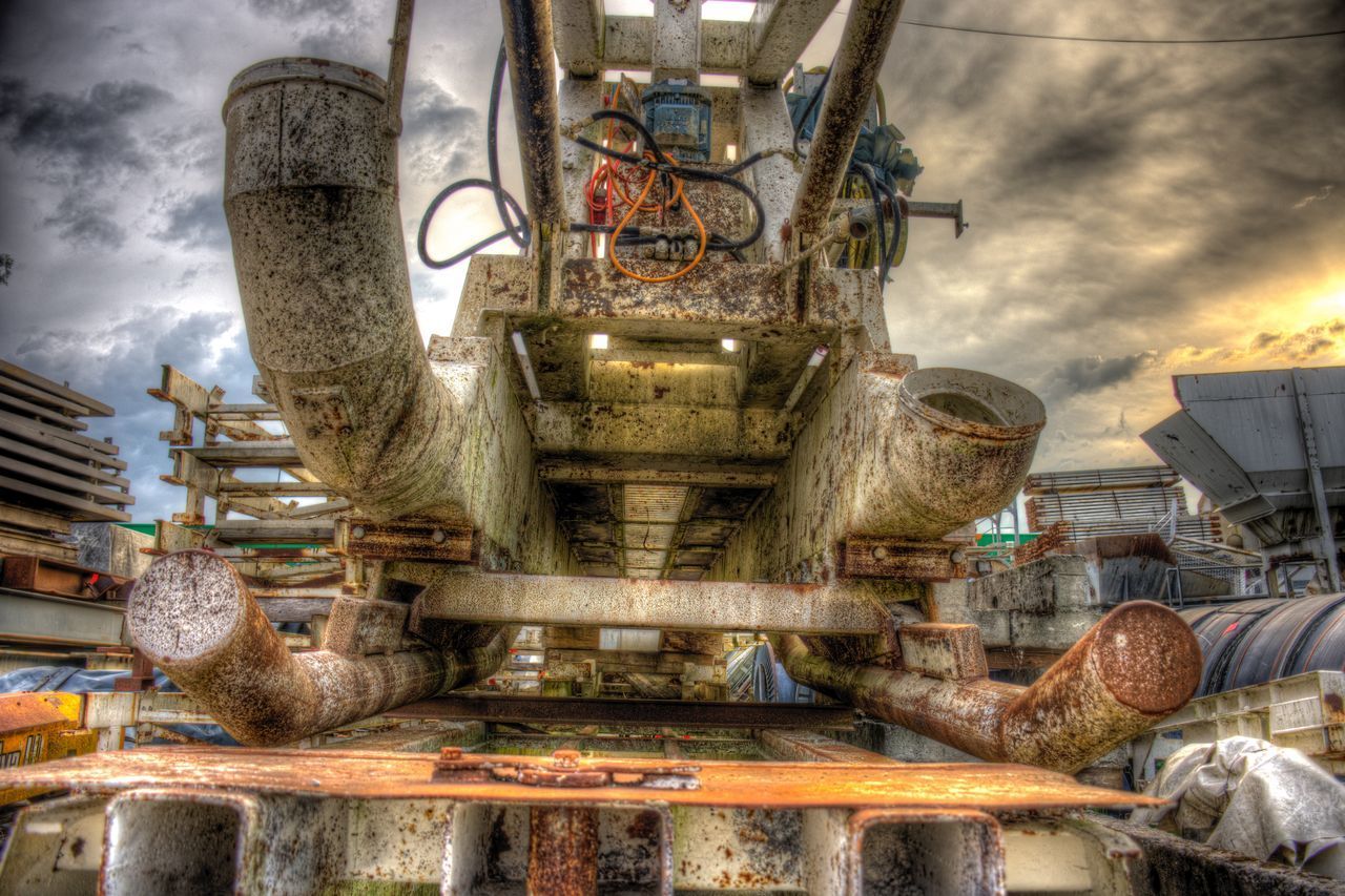 VIEW OF OLD MACHINE AGAINST SKY