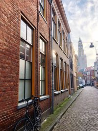 Footpath amidst buildings in city