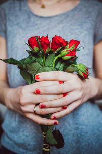 Close-up of woman holding rose bouquet