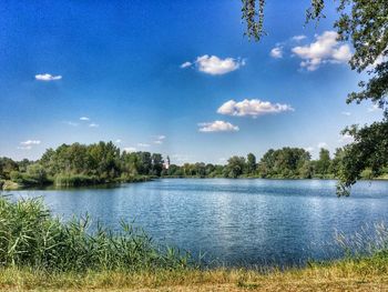 Scenic view of lake against cloudy sky
