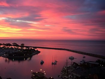 Boats in sea at sunset