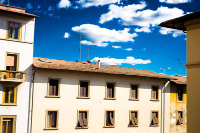 Low angle view of building against cloudy sky