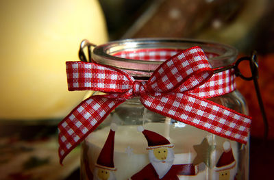 Close-up of tied ribbon on open jar