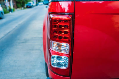 Close-up of red car on road