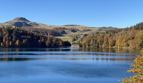 Scenic view of lake and mountains against clear sky