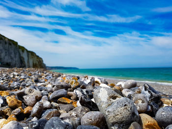 Rocks on beach against sky