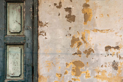 The old yellow cement concrete wall and old wood window