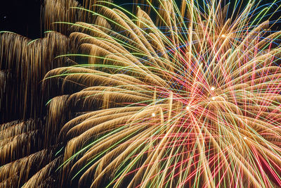 Low angle view of firework display at night