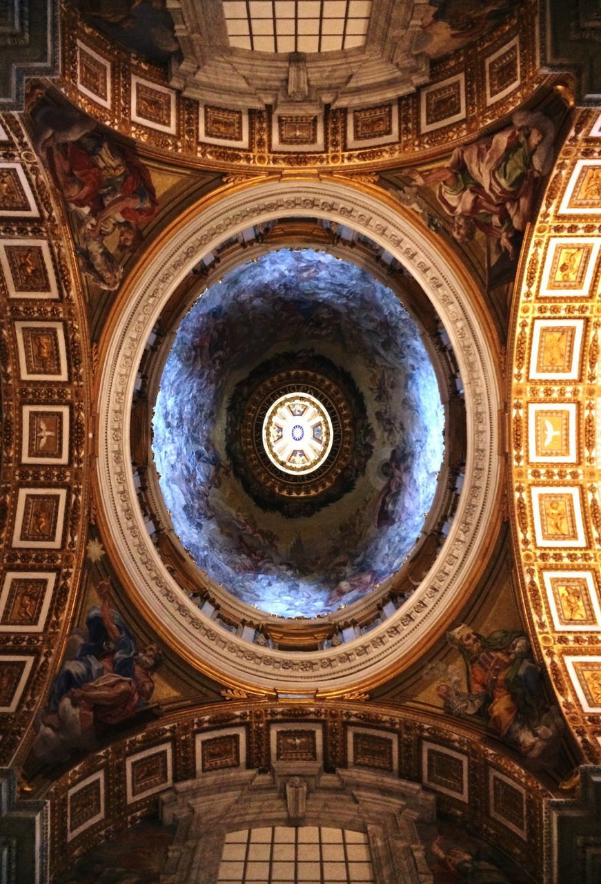 DIRECTLY BELOW SHOT OF ORNATE CEILING OF BUILDING