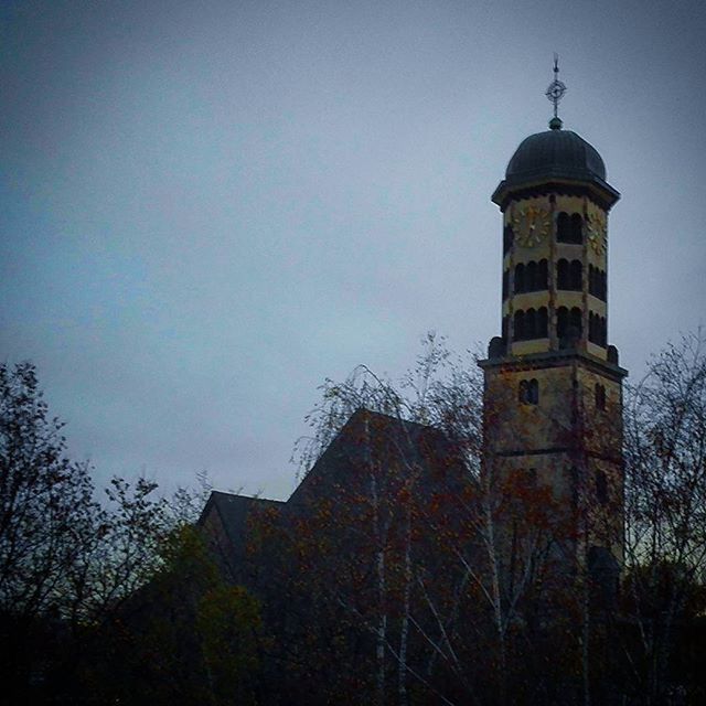 architecture, built structure, building exterior, low angle view, tower, clear sky, tree, sky, religion, tall - high, place of worship, history, copy space, outdoors, spirituality, church, no people, bare tree, blue