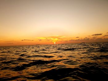Scenic view of sea against romantic sky at sunset