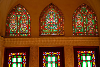 Low angle view of stained glass window of building