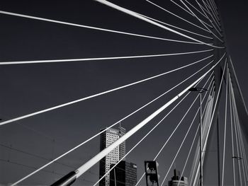 Low angle view of suspension bridge against sky