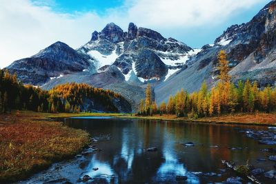 Scenic view of snowcapped mountain against cloudy sky