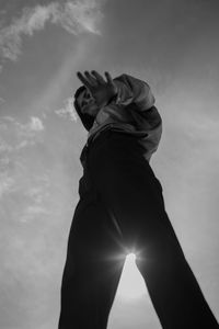 Directly below shot of woman standing against sky