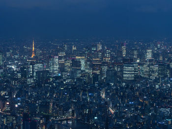 Aerial view of city lit up at night