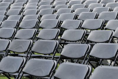 Full frame shot of empty chairs arranged on field