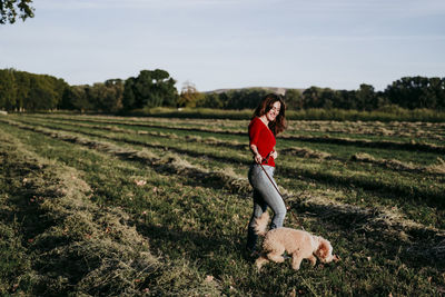 Woman walking with dog on land