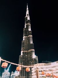 Low angle view of illuminated building at night