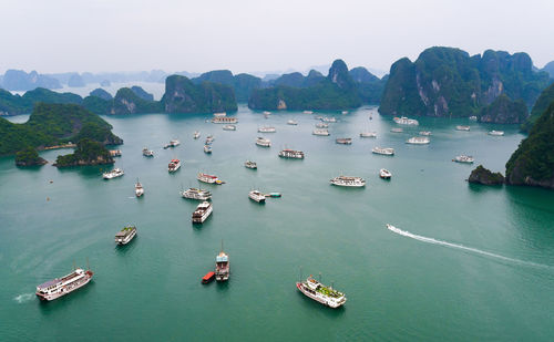 High angle view of boats sailing on river against sky