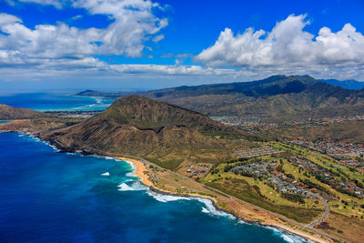 Scenic view of sea and mountains against sky