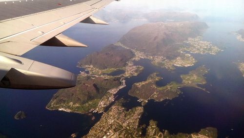 Cropped image of airplane flying over sea