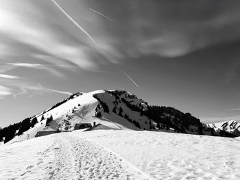 Scenic view of snow covered mountain against sky