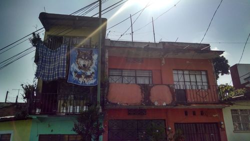 Low angle view of clothes drying against sky