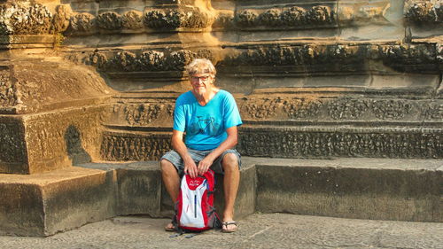 Portrait of man sitting on staircase