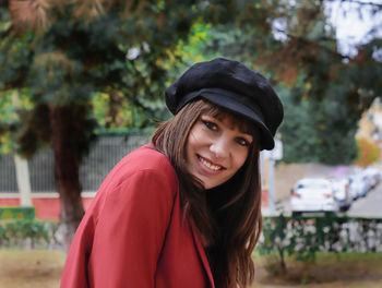 Portrait of smiling young woman standing outdoors