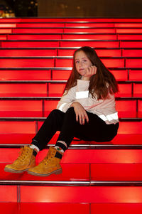 Portrait of cute girl sitting on staircase