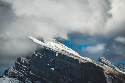 Low angle view of snow covered mountain against sky