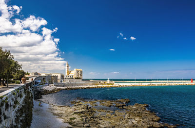 Scenic view of sea against sky in city