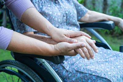 Cropped hands of nurse consoling patient