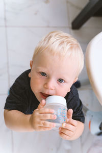 Portrait of cute boy drinking milk