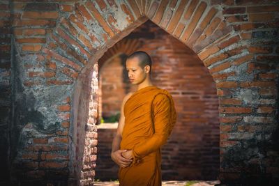 Man standing against wall