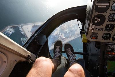 Low section of man sitting in helicopter