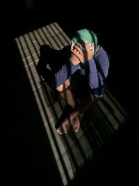 High angle view of man lying on black background