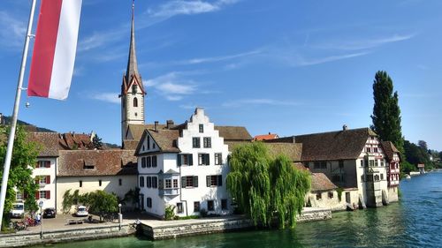 Panoramic view of buildings and trees against sky