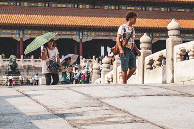 Group of people walking in front of building
