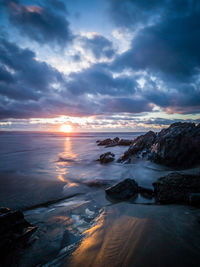 View of dramatic sky over sea during sunset