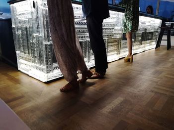 Low section of people standing on wooden floor