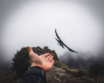 Midsection of person holding hands during foggy weather