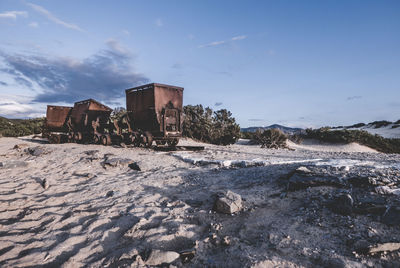 Abandoned built structure in winter against sky