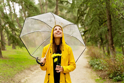 Portrait of young woman holding umbrella