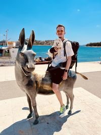 Rear view of man with dog on beach