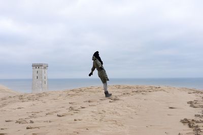 Silhouette of woman standing on beach